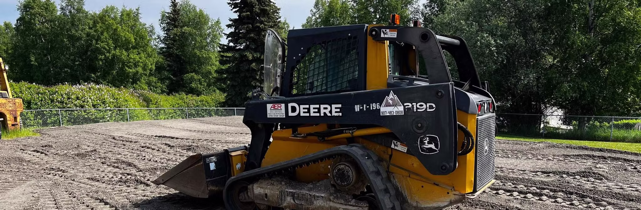 Parked skid steer on sunny day